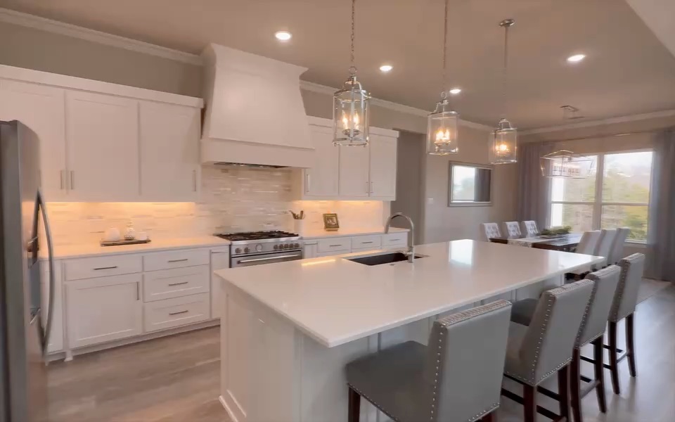 From my listing film for 4571 Lake Breeze Dr in McKinney: the white kitchen, then the front porch